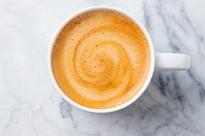 Coffee, espresso in white cup of marble table background. Top view. Copy space